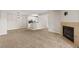 Open living space with a fireplace, neutral carpet, and view into the adjacent kitchen at 2200 S Fort Apache Rd # 1033, Las Vegas, NV 89117