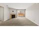 Spacious living room with fireplace and sliding glass doors leading to an outdoor patio at 2200 S Fort Apache Rd # 1033, Las Vegas, NV 89117