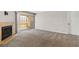 Bright living room featuring a fireplace, sliding glass doors to the patio, and neutral carpet at 2200 S Fort Apache Rd # 1033, Las Vegas, NV 89117