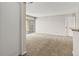 Bright living room with sliding glass doors to the patio and neutral carpeting throughout at 2200 S Fort Apache Rd # 1033, Las Vegas, NV 89117