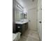 Bathroom with a vanity, large mirror, and wood-look flooring offers a clean, modern look at 2229 Steele St, Las Vegas, NV 89156