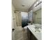 Bright bathroom features a tub shower with a patterned curtain, and a large, white countertop at 2229 Steele St, Las Vegas, NV 89156