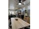 Bright dining area featuring a wood table with seating for six and a modern ceiling fan at 2229 Steele St, Las Vegas, NV 89156