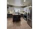 Well-equipped kitchen with stainless steel appliances, gray cabinetry, mosaic backsplash, and a functional kitchen island at 2229 Steele St, Las Vegas, NV 89156