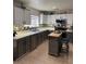 Well-equipped kitchen with stainless steel appliances, gray cabinetry, mosaic backsplash, and a functional kitchen island at 2229 Steele St, Las Vegas, NV 89156