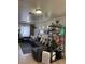 Inviting living room featuring tile floors, neutral walls and a comfortable sectional sofa with decorative shelving at 2229 Steele St, Las Vegas, NV 89156