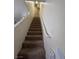Carpeted staircase leading to the upper level of the home, bright with neutral colors at 2229 Steele St, Las Vegas, NV 89156