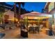 Cozy backyard featuring a hot tub, gazebo-covered dining area, and lush landscaping, perfect for outdoor entertaining at 2232 Le Conte Ave, Henderson, NV 89074