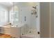 Bathroom featuring a modern glass-enclosed shower and a separate soaking tub at 2232 Le Conte Ave, Henderson, NV 89074