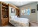 Cozy bedroom with custom built-in wall unit, window with backyard view, and ceiling fan at 2232 Le Conte Ave, Henderson, NV 89074