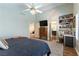 Bright bedroom showcases a ceiling fan, wood floors, built-in shelves, and a work station at 2232 Le Conte Ave, Henderson, NV 89074