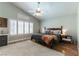 Well-lit bedroom features a ceiling fan, wood floors, white rug, and shuttered windows at 2232 Le Conte Ave, Henderson, NV 89074