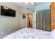 Comfortable bedroom with access to the ensuite bathroom and television on the wall at 2232 Le Conte Ave, Henderson, NV 89074