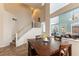 Cozy dining area with a wooden table and chairs, open to the living room and staircase at 2232 Le Conte Ave, Henderson, NV 89074