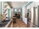 Open concept kitchen with stainless appliances that flows into the living room at 2232 Le Conte Ave, Henderson, NV 89074