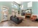 Bright living room featuring a fireplace, comfortable seating, and views of the landscaped backyard at 2232 Le Conte Ave, Henderson, NV 89074