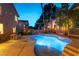 Backyard with a large, sparkling pool featuring elegant lighting and a serene water fountain feature at 2232 Le Conte Ave, Henderson, NV 89074