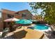 Outdoor pool and spa combination boasts mature trees, patio seating, and lush landscaping at 2232 Le Conte Ave, Henderson, NV 89074