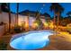 Stunning backyard pool area with elegant lighting, lush greenery, and a tranquil water feature at 2232 Le Conte Ave, Henderson, NV 89074