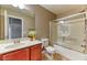 Bathroom featuring a single vanity, toilet, and shower-tub combo with sliding glass doors at 2264 Steamers Ave # 102, Las Vegas, NV 89183