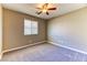 Comfortable bedroom with plush carpet, a ceiling fan, and a bright window at 2264 Steamers Ave # 102, Las Vegas, NV 89183