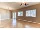 Bright living room with tile flooring, two windows, and a sliding door for easy outdoor access at 2264 Steamers Ave # 102, Las Vegas, NV 89183