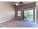 A bright main bedroom with sliding glass door to a private balcony and neutral decor at 2264 Steamers Ave # 102, Las Vegas, NV 89183