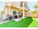 Back patio with artificial turf, gas grill, and outdoor seating, perfect for entertaining at 2264 Steamers Ave # 102, Las Vegas, NV 89183