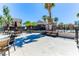 Outdoor lounge area with tables, chairs and umbrellas near the community pool at 2264 Steamers Ave # 102, Las Vegas, NV 89183