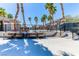 Comfortable seating on the pool deck featuring palm trees and a glimpse of the pool at 2264 Steamers Ave # 102, Las Vegas, NV 89183