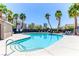 Community pool and deck with palm trees and lounge chairs for relaxation and enjoyment at 2264 Steamers Ave # 102, Las Vegas, NV 89183