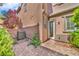 Backyard features paved brick patio, plants, small garden and rear access door at 2432 Granada Bluff Ct, Las Vegas, NV 89135