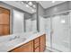 Bathroom featuring a double vanity sink and glass enclosed shower at 2432 Granada Bluff Ct, Las Vegas, NV 89135