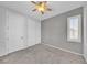 Comfortable bedroom featuring carpet floors, a window with shutters, closet, and ceiling fan at 2432 Granada Bluff Ct, Las Vegas, NV 89135