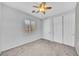 Neutral bedroom with carpet flooring, white trim and doors, with a ceiling fan and shuttered window at 2432 Granada Bluff Ct, Las Vegas, NV 89135
