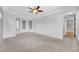 Spacious carpeted bedroom featuring tray ceilings and a ceiling fan at 2432 Granada Bluff Ct, Las Vegas, NV 89135