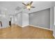 Hardwood bedroom with a ceiling fan and a view of the staircase at 2432 Granada Bluff Ct, Las Vegas, NV 89135