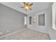 Bedroom featuring carpet flooring, a window with shutters, recessed wall niches, and ceiling fan at 2432 Granada Bluff Ct, Las Vegas, NV 89135