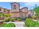 Charming two-story home with a red tile roof, a small balcony, and well-maintained landscaping at 2432 Granada Bluff Ct, Las Vegas, NV 89135