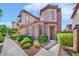 Charming stucco home with red tile roof, manicured landscaping, and sidewalk leading to the front door at 2432 Granada Bluff Ct, Las Vegas, NV 89135