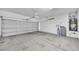 Spacious garage featuring an automatic door, water heater, water softener, and ample storage space at 2432 Granada Bluff Ct, Las Vegas, NV 89135