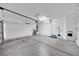 Spacious garage featuring ample storage space, lighting, and an automatic garage door at 2432 Granada Bluff Ct, Las Vegas, NV 89135