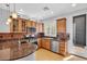 Kitchen featuring wood cabinets, granite countertops, tile backsplash, and stainless steel appliances at 2432 Granada Bluff Ct, Las Vegas, NV 89135
