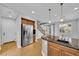 Open kitchen boasts stainless steel appliances, wood cabinets, granite counters, and ample storage at 2432 Granada Bluff Ct, Las Vegas, NV 89135