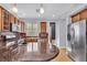 Kitchen with stainless steel appliances, wood cabinetry, granite countertops, and a tile backsplash at 2432 Granada Bluff Ct, Las Vegas, NV 89135