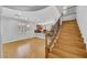 Open living area with wood floors, staircase, and a view into the kitchen at 2432 Granada Bluff Ct, Las Vegas, NV 89135