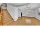 Bright living room features wood floors, tray ceiling with fan, fireplace, and staircase at 2432 Granada Bluff Ct, Las Vegas, NV 89135