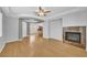 Spacious living room featuring wood floors, fireplace, tray ceiling with fan, and access to other rooms at 2432 Granada Bluff Ct, Las Vegas, NV 89135