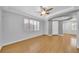 Bright living room with wood floors, plantation shutters, tray ceiling and adjacent rooms at 2432 Granada Bluff Ct, Las Vegas, NV 89135