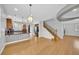 Open living space with wood floors, kitchen island, and staircase at 2432 Granada Bluff Ct, Las Vegas, NV 89135